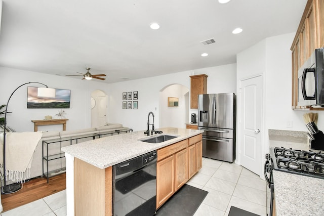 kitchen featuring dishwasher, a center island with sink, stainless steel fridge with ice dispenser, light tile patterned floors, and sink