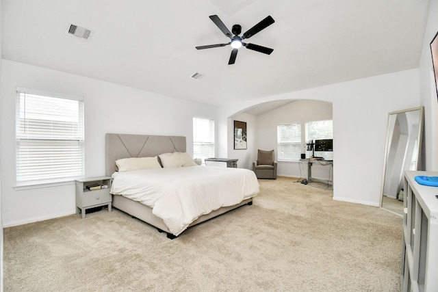 bedroom featuring lofted ceiling, light colored carpet, and ceiling fan