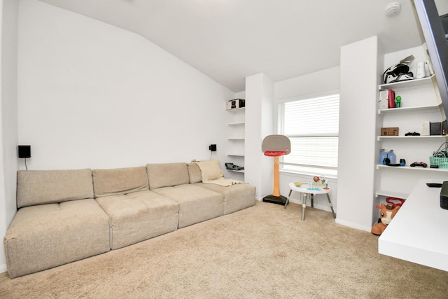 carpeted living room featuring vaulted ceiling