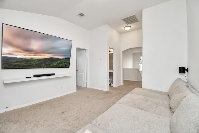 living room with vaulted ceiling and light carpet