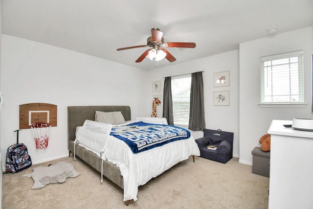 bedroom featuring ceiling fan and light carpet