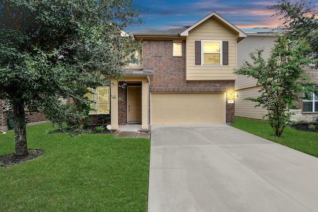 view of front of home featuring a garage and a yard