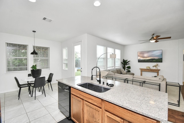 kitchen featuring dishwasher, hanging light fixtures, light stone countertops, light tile patterned floors, and ceiling fan