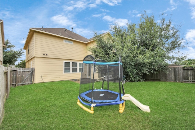 exterior space with a lawn and a trampoline