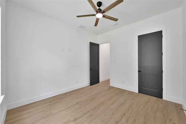 empty room featuring ceiling fan and light hardwood / wood-style flooring