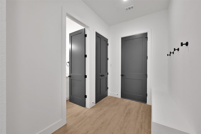 hallway with light hardwood / wood-style flooring