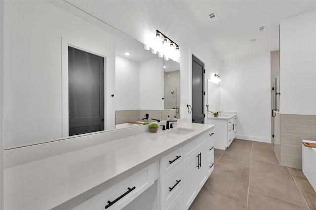 bathroom with vanity, tile patterned flooring, and a shower with shower door