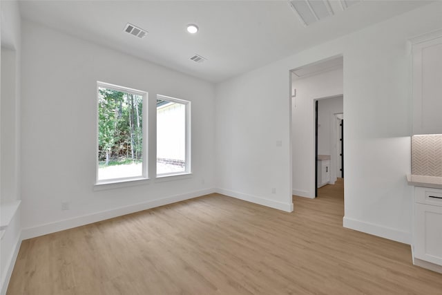 spare room featuring light wood-type flooring