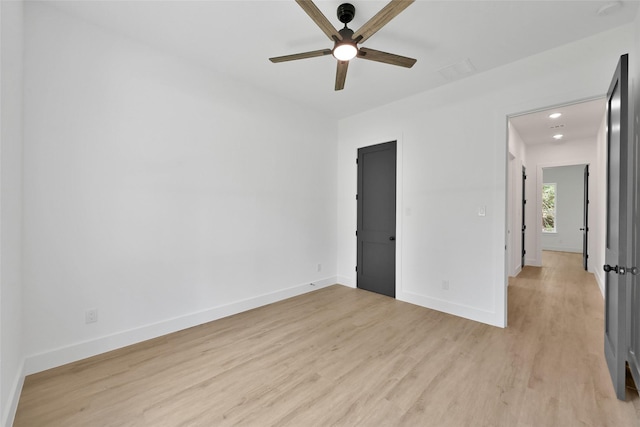 empty room featuring light wood-type flooring and ceiling fan