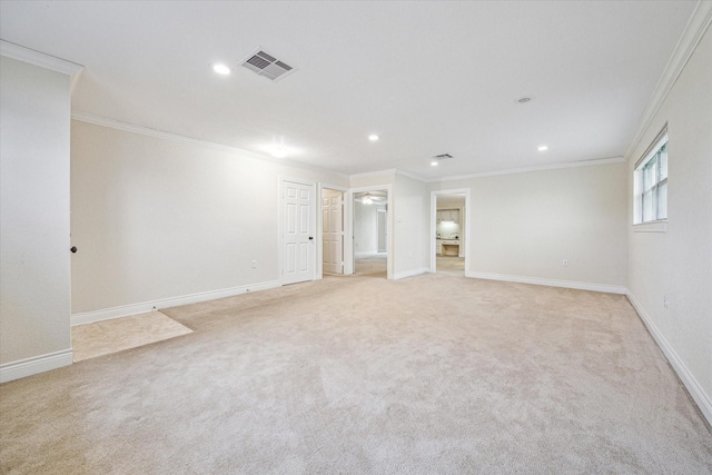 spare room featuring light carpet and crown molding