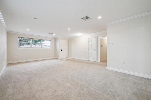 carpeted spare room featuring crown molding