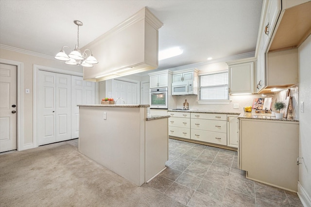 kitchen featuring decorative light fixtures, a notable chandelier, a kitchen island, stainless steel oven, and light carpet