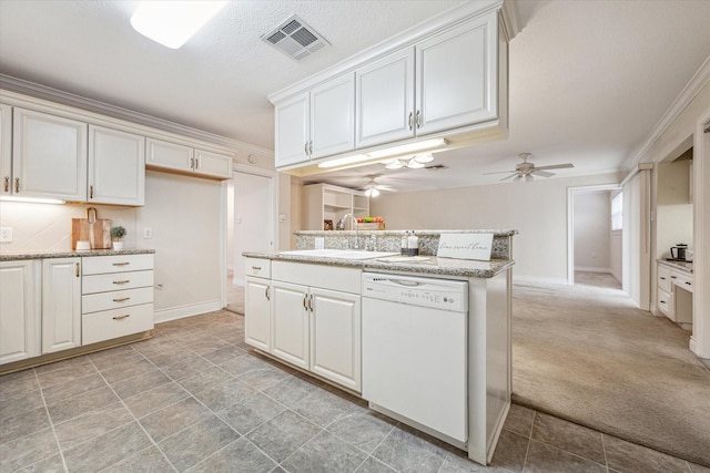 kitchen featuring light colored carpet, white cabinets, dishwasher, and ornamental molding