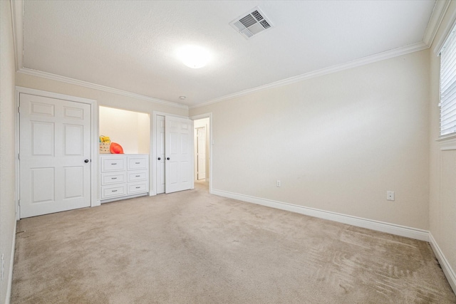 unfurnished bedroom featuring light colored carpet and crown molding