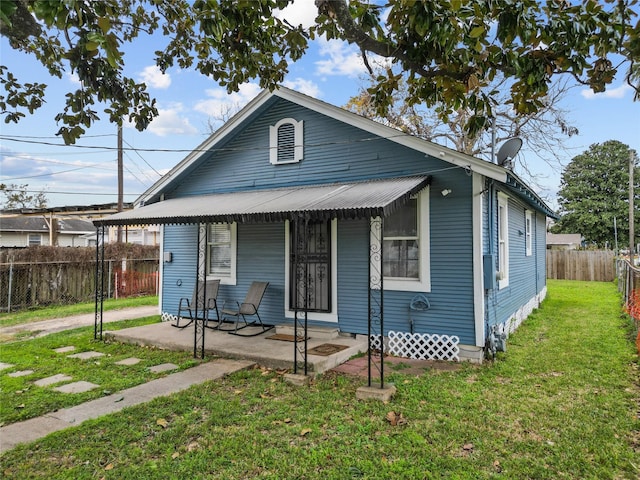 bungalow-style house with a patio and a front lawn