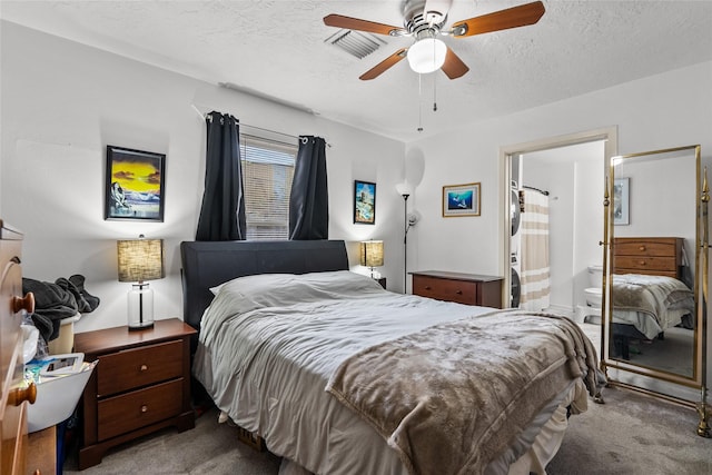 carpeted bedroom featuring ceiling fan, ensuite bathroom, and a textured ceiling