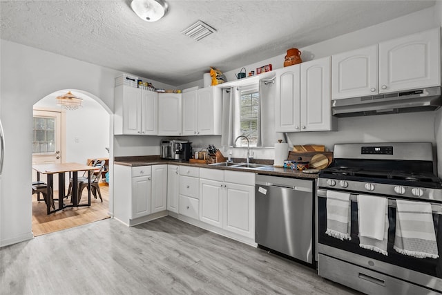 kitchen with sink, appliances with stainless steel finishes, light hardwood / wood-style floors, and white cabinetry