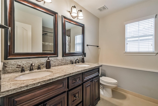 bathroom with toilet and vanity