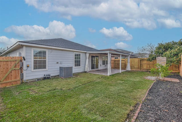 back of property featuring a yard, cooling unit, and a patio area