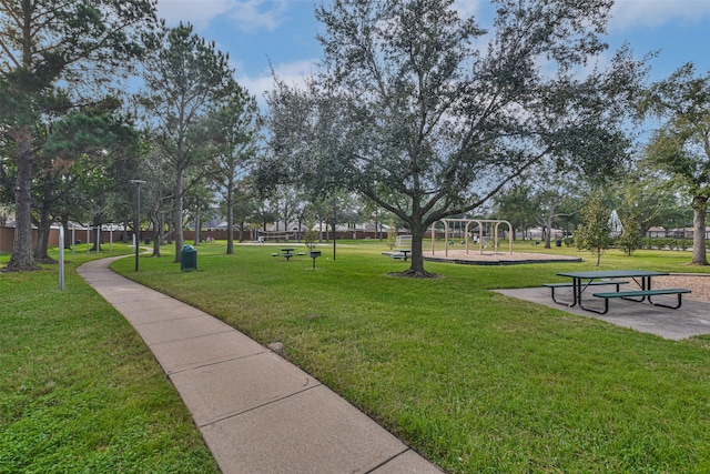 view of community featuring a playground and a yard