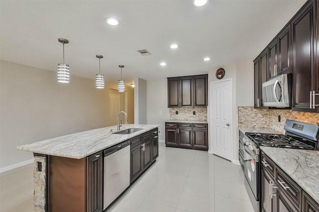 kitchen with decorative light fixtures, stainless steel appliances, backsplash, and sink