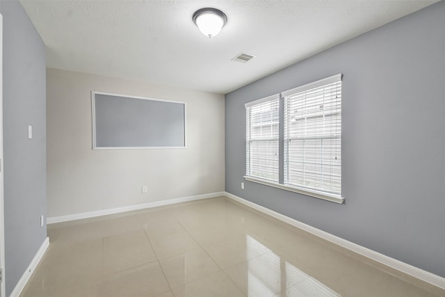 spare room with light tile patterned floors