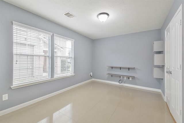 empty room with a textured ceiling