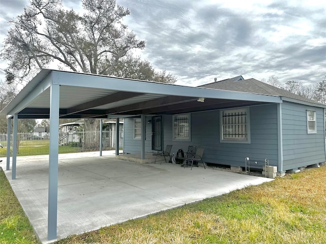 back of property with a carport