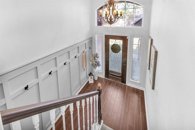 foyer with a notable chandelier and dark hardwood / wood-style floors