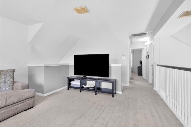 living room with lofted ceiling and light carpet