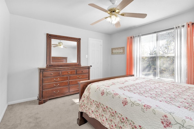 bedroom with ceiling fan and light colored carpet