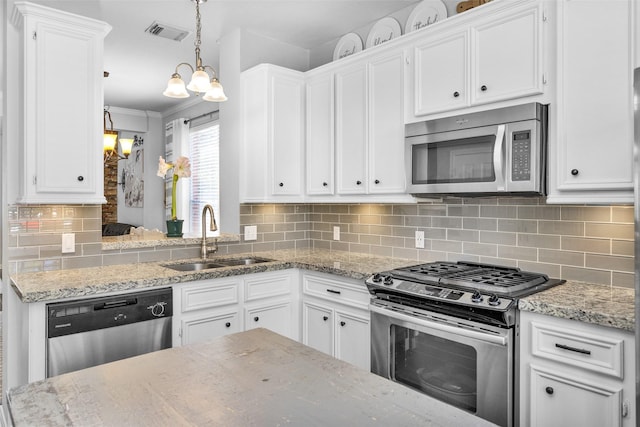 kitchen featuring white cabinets, appliances with stainless steel finishes, and sink