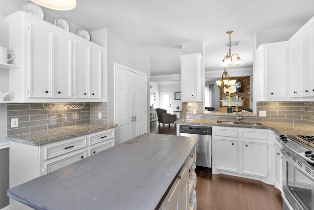 kitchen with backsplash, stainless steel appliances, white cabinets, and sink