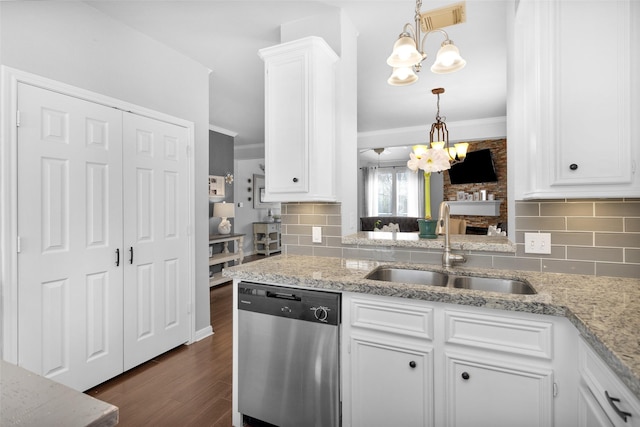 kitchen featuring sink, white cabinets, stainless steel dishwasher, hanging light fixtures, and a notable chandelier