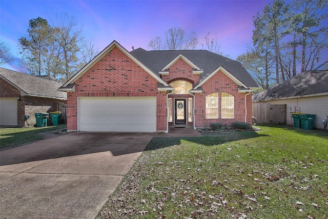 front of property featuring a yard and a garage