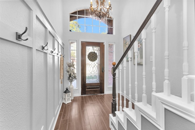 foyer entrance with a towering ceiling and a chandelier