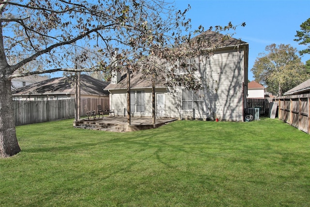 rear view of house with a yard