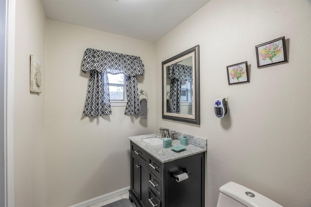 bathroom with tile patterned floors, vanity, and toilet