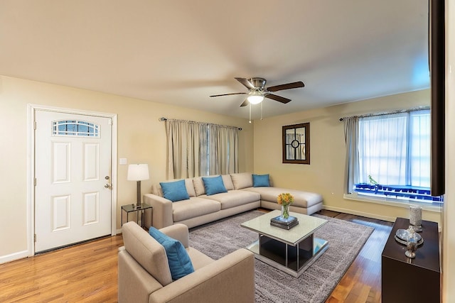 living room with hardwood / wood-style flooring and ceiling fan