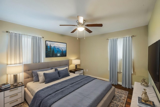 bedroom featuring ceiling fan and dark wood-type flooring