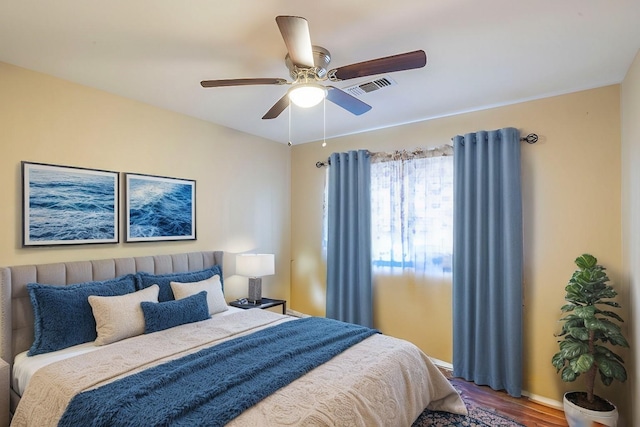 bedroom with ceiling fan and wood-type flooring