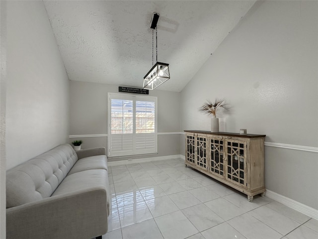 living room featuring a textured ceiling, vaulted ceiling, and a chandelier