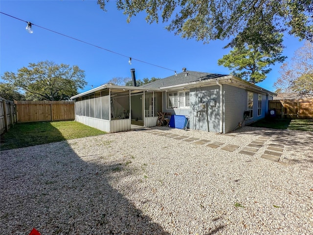 back of house featuring a sunroom and a patio area