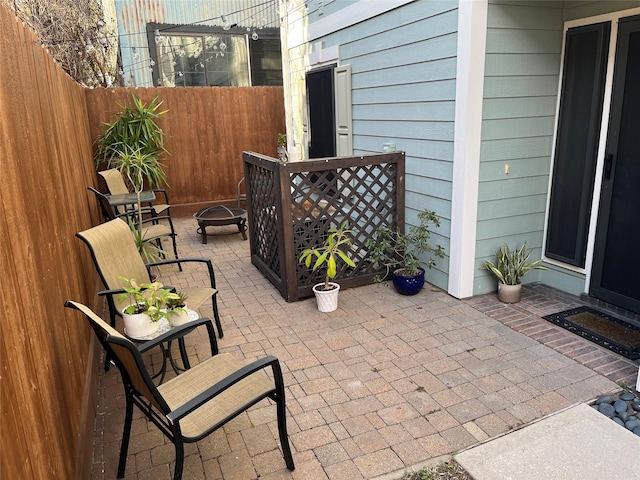 view of patio with a fire pit