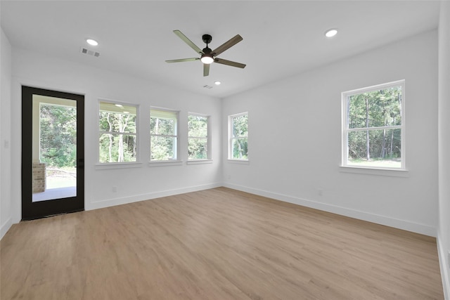 spare room with ceiling fan and light wood-type flooring