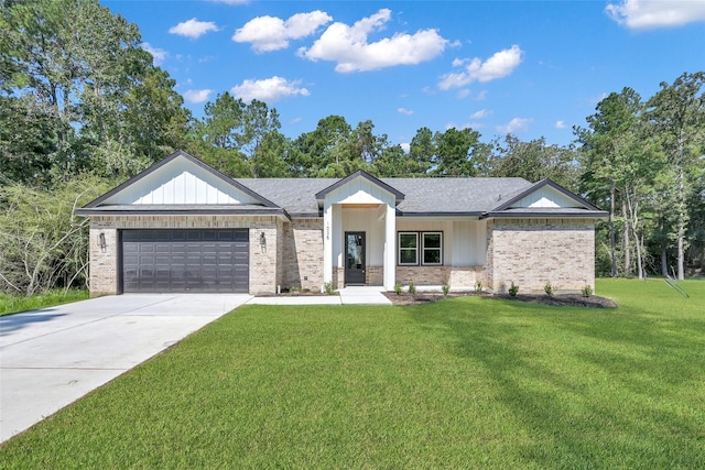 view of front of home with a front yard and a garage