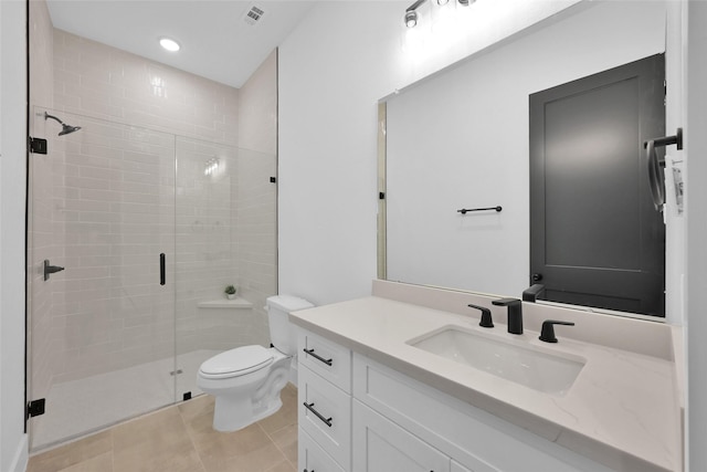 bathroom with toilet, a shower with shower door, tile patterned floors, and vanity