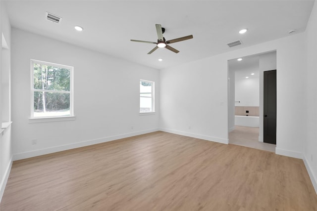 spare room with light hardwood / wood-style floors and ceiling fan