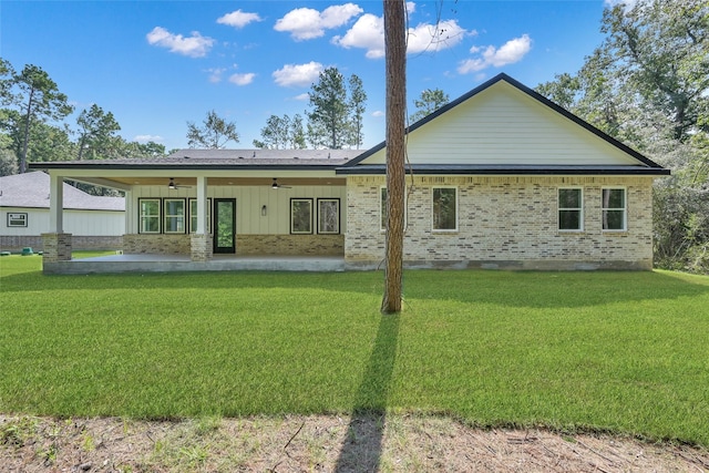 rear view of property featuring a patio, ceiling fan, and a lawn