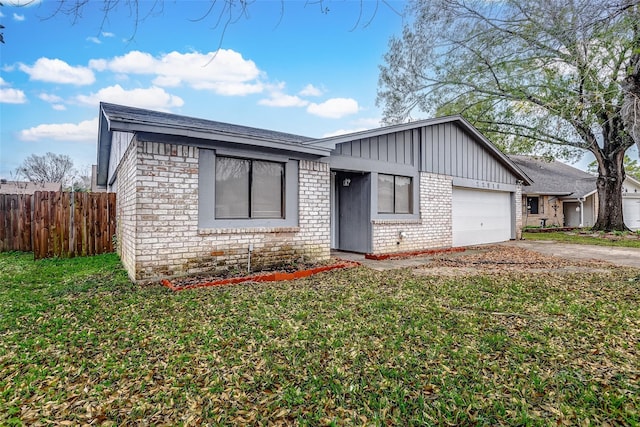 view of front of property with a front yard and a garage